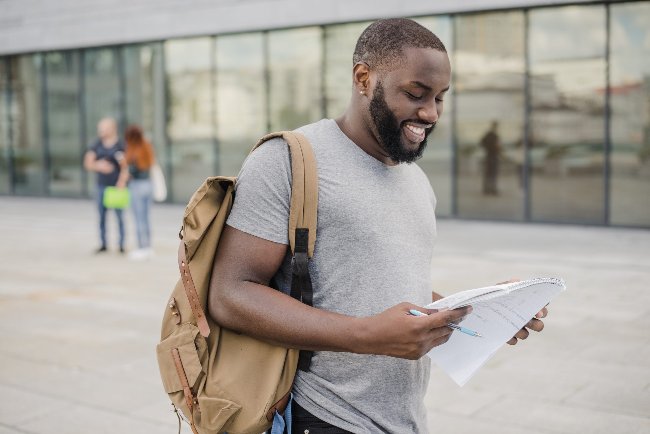 male-student-holding-papers